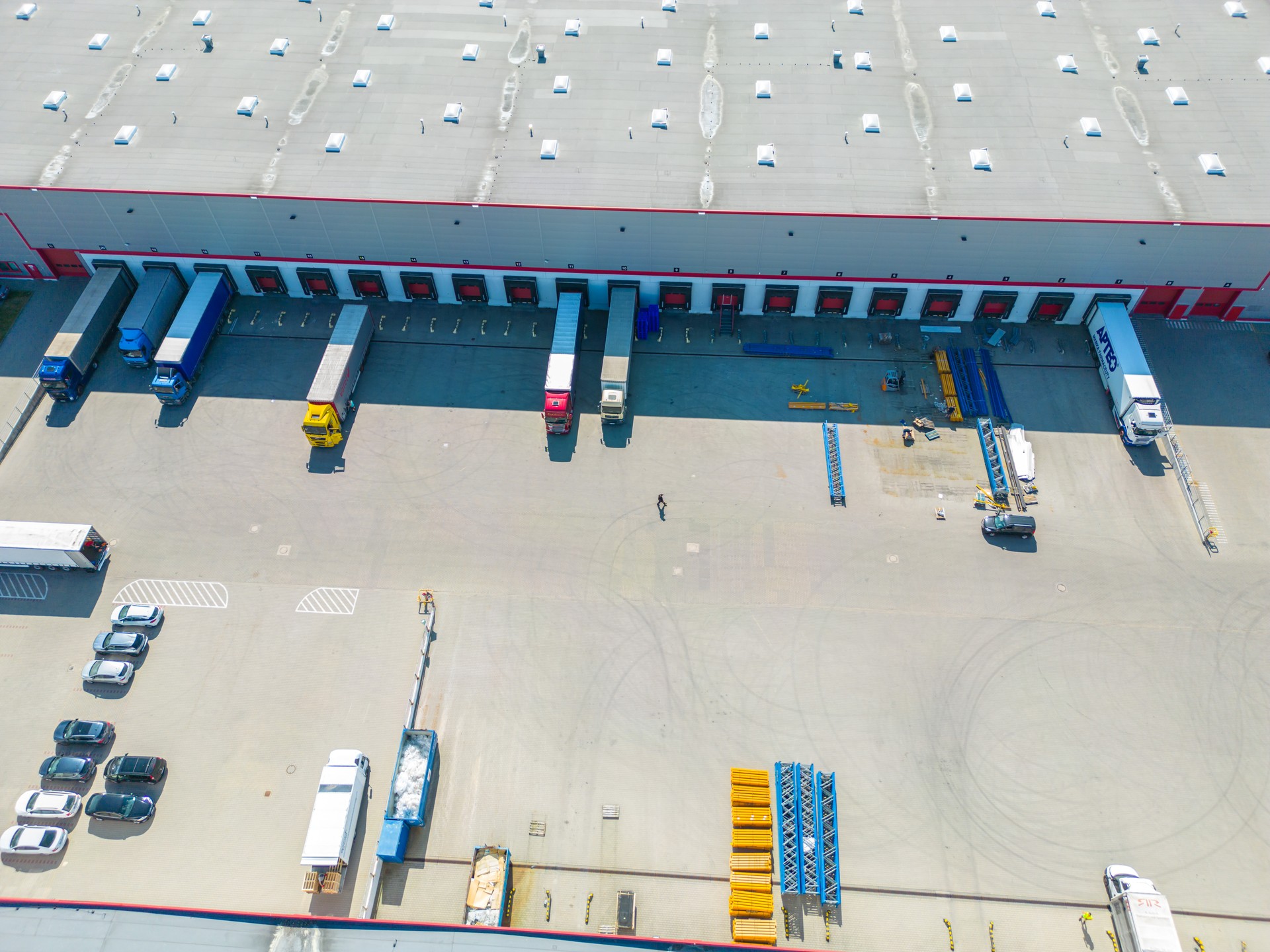 Aerial view of distribution center, drone photo of industrial logistics zone,new super modern logistics center full of modern technology and robotics,roof solar power plant for green energy production